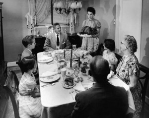 family-sits-at-a-formally-prepared-dinner-gettyimages-610x484